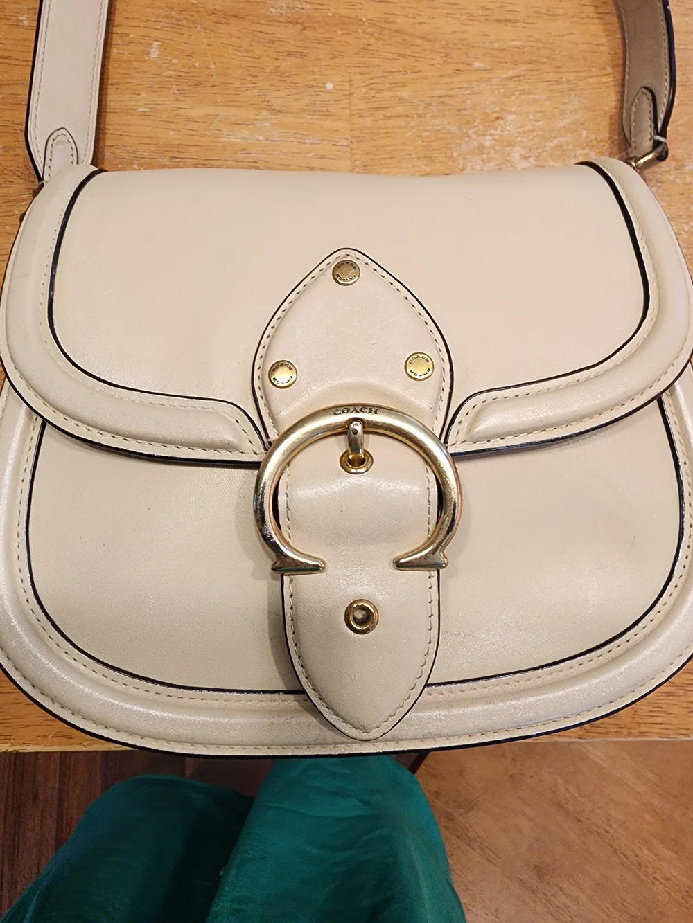 2021 Ivory Coach Beat saddle bag is crafted from glovetanned leather and brass